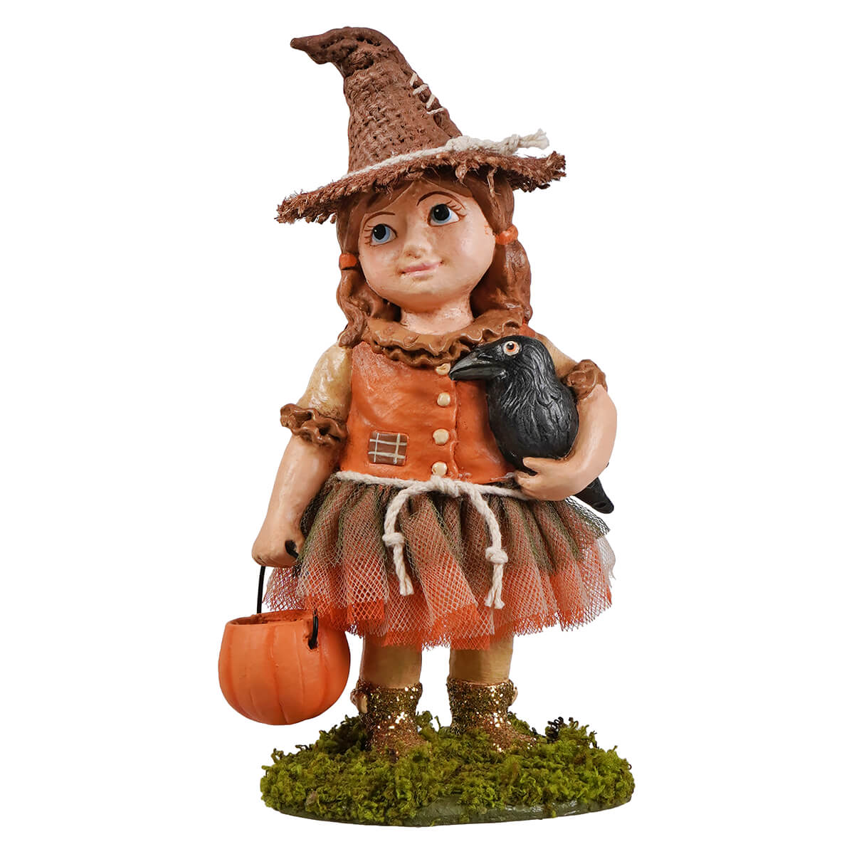 A detailed scarecrow figurine of a young witch in an orange dress with a brown hat holding a black crow and pumpkin bucket