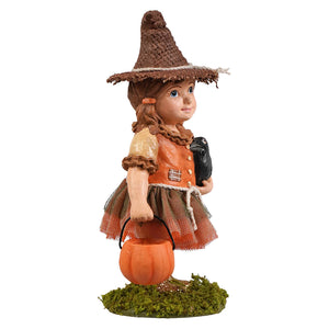 Detailed scarecrow figurine of a young witch in an orange dress with brown hat holding a pumpkin bucket and bird