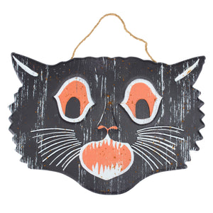 Black cat face wall hanging with orange eyes mouth and white whiskers is a spooky scary cat face wall decor