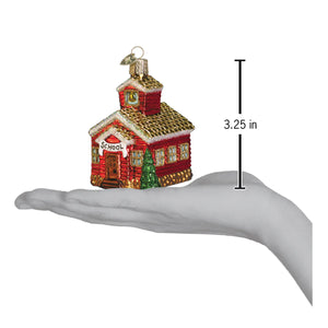 Red glass school house ornament with gold trim and green tree figural decor perfect for holiday glass and glitter collections
