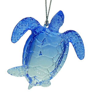 Blue translucent glass sea turtle ornament with faceted shell and detailed flippers, perfect next to a sparkle scallop shell ornament