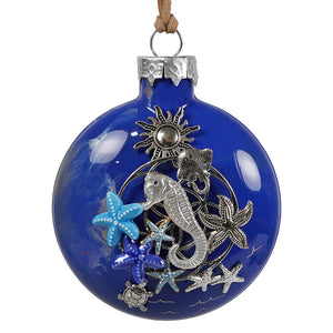 A vibrant cobalt blue seahorse and ocean treasures ornament with silver and multicolored applied metal starfish by bette fraser