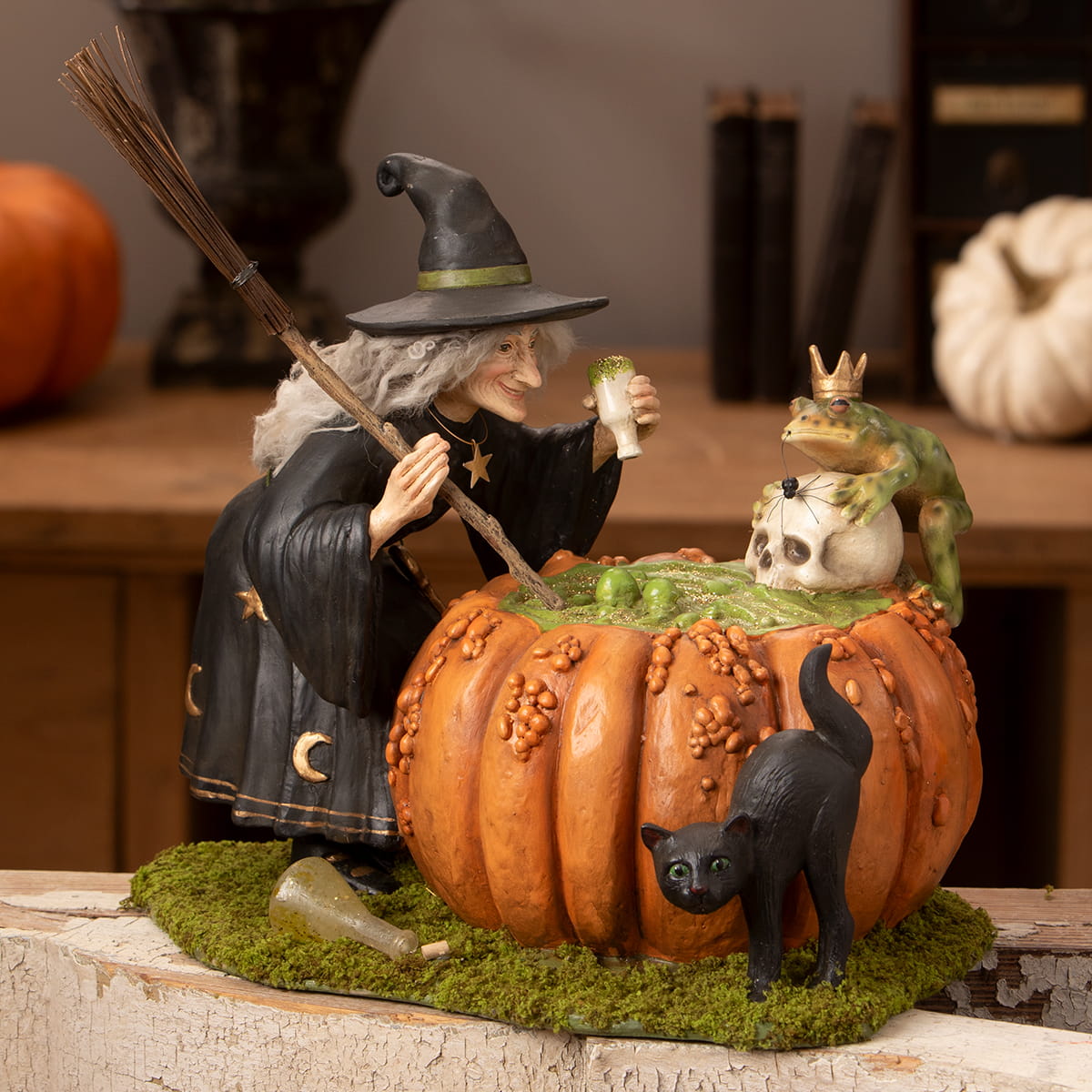 Orange pumpkin-shaped cauldron with green bubbling liquid and black cat for halloween witches prince potion fun