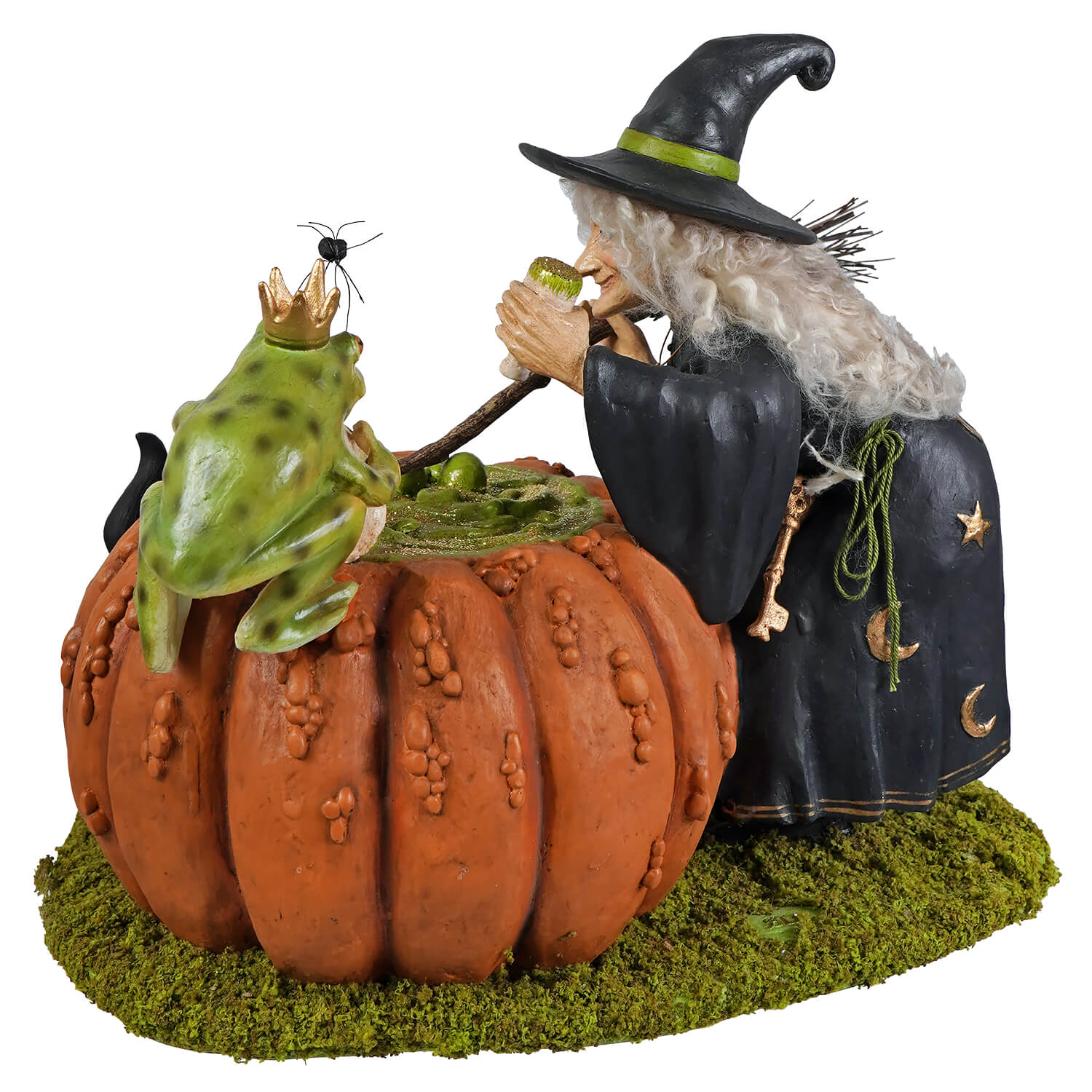 A whimsical halloween witches figurine in black cloak with gold stars blowing a pipe beside a prince potion pumpkin