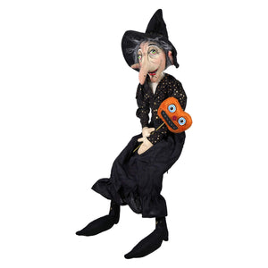 Black witch figurine shasta wearing polka dot dress and hat holding orange pumpkin mask joe spencer halloween dolls and decor