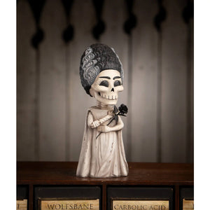 Off-white resin shelley skelly figurine of a skeleton dressed as marie antoinette holding a black rose