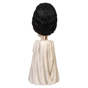 Shelley Skelly black-haired bobblehead figurine wearing a cream-colored draped cape for collectors and fans