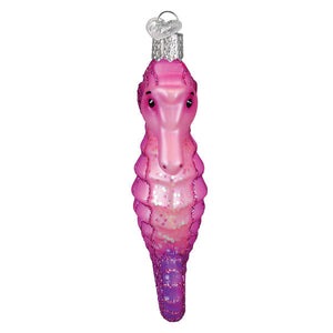 A pink and purple gradient glass seahorse ornament with glittery details and a silver heart-shaped cap.
