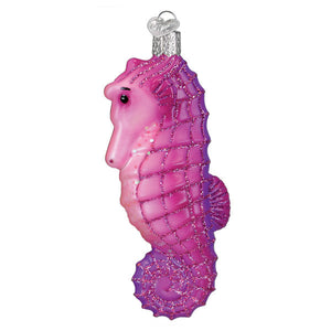 Bright seahorse ornament made of pink and purple glittery glass with a silver cap perfect for marine life ornaments
