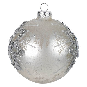 A frosted silver jeweled mercury glass floral design ball ornament with glittery branches and clear crystals