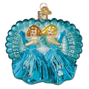 A shimmering blue glass ornament featuring two blonde sisters in turquoise gowns with sisters engraved fairy tale princess ornament