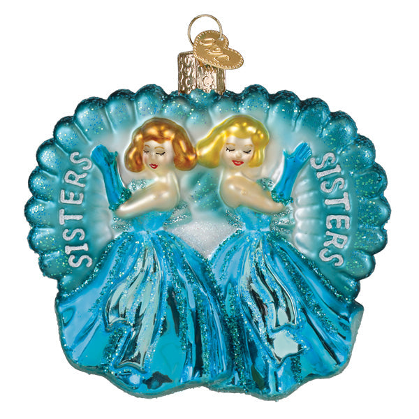 A shimmering blue glass ornament featuring two blonde sisters in turquoise gowns with sisters engraved fairy tale princess ornament