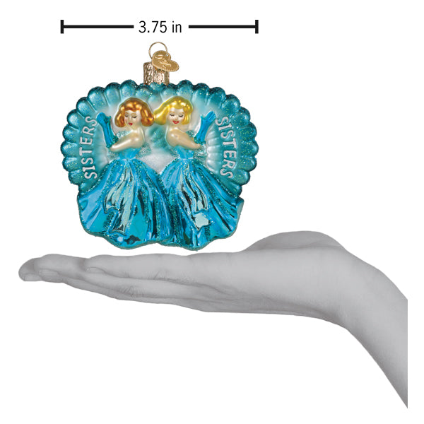 Translucent blue glass princess ornament with two golden-haired sisters in teal gowns and scalloped sister frame