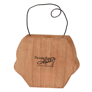 A rustic light brown wooden skeleton face chunky wall hanging with natural grain finish and black wire handle by phil chapman design