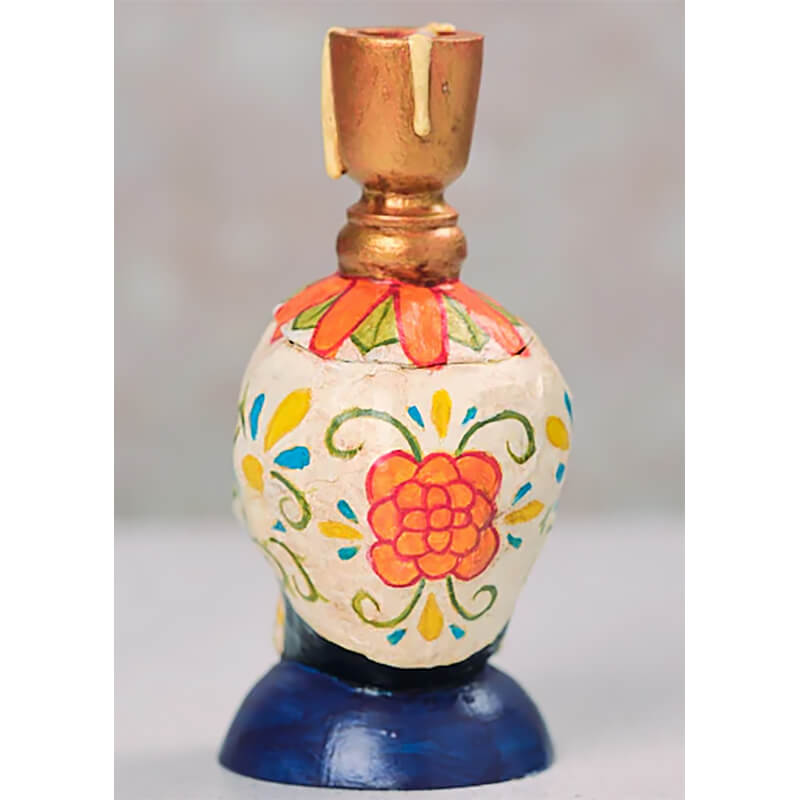 Decorative perfume bottle with floral folk art patterns painted in orange, yellow and blue.