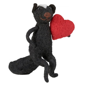 Black felt skunk critter ornament with white stripe holding a red heart perfect as a valentine skunk gift