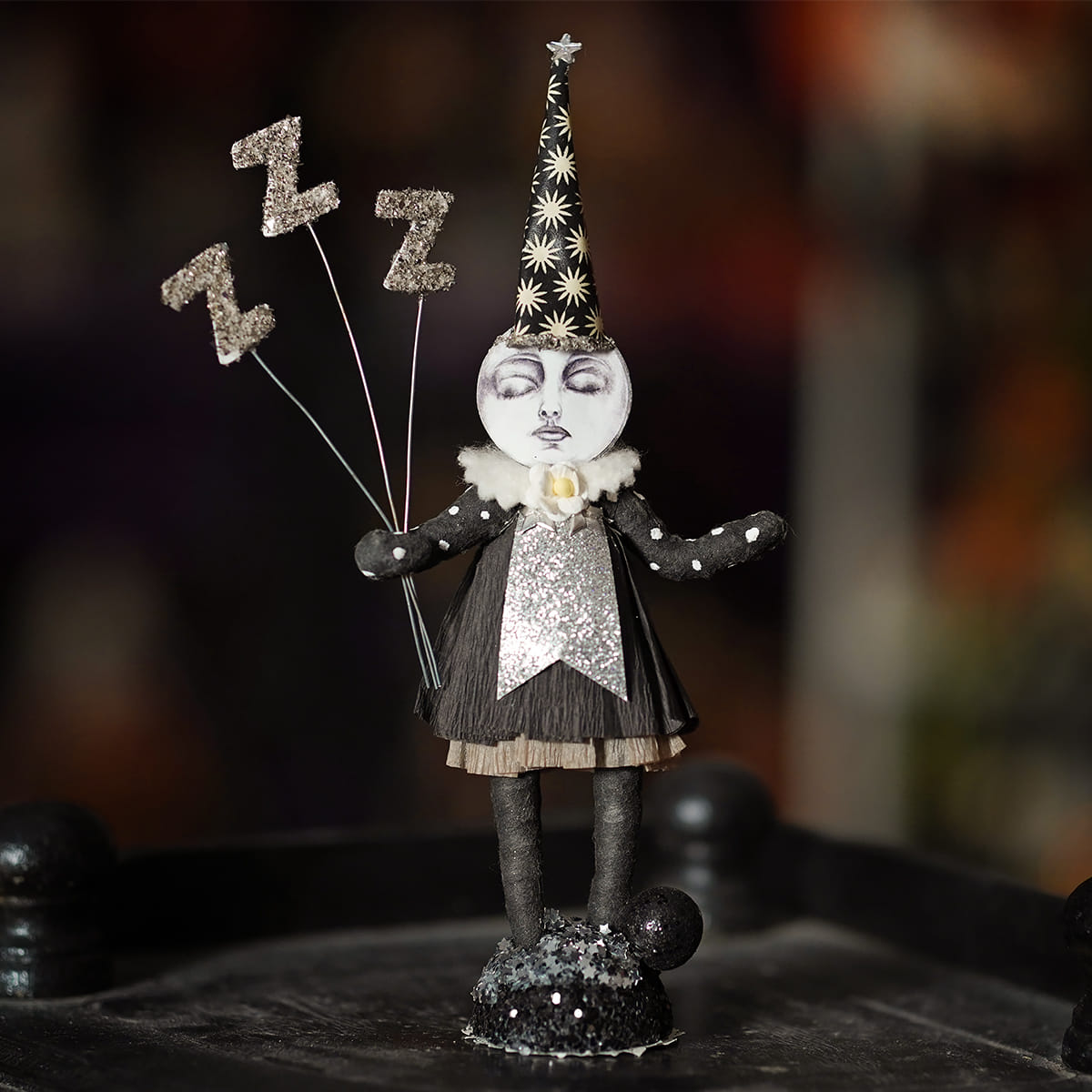 Whimsical black and silver sleeping moon girl figure holding glittery zz balloons with star pattern party hat