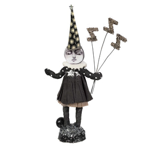 A whimsical black and white sleeping moon girl figure with a star party hat holding glittery zigzag balloons