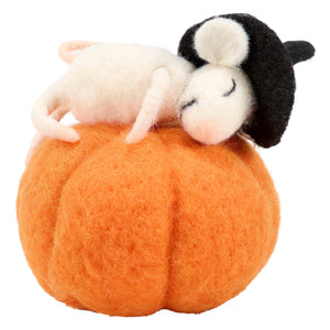 A cozy black and white needle-felted mouse from kathy’s halloween collection rests on an orange pumpkin next to halloween cats
