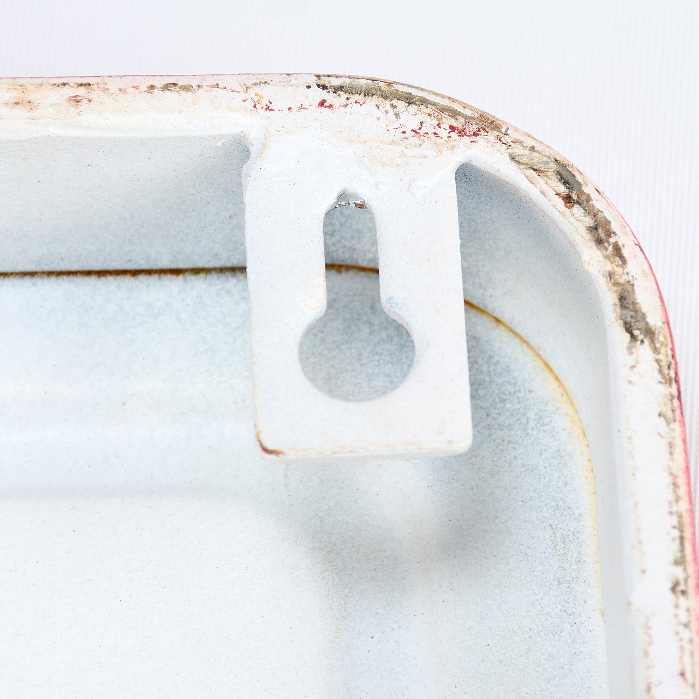 White enamel wall-mounted sleigh rides wall decor with chipped paint and keyhole slot for santa’s sleigh block hanging