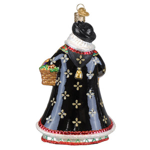 Black glass christmas glass ornament of a slovak father christmas woman in an ornate gown holding a woven basket