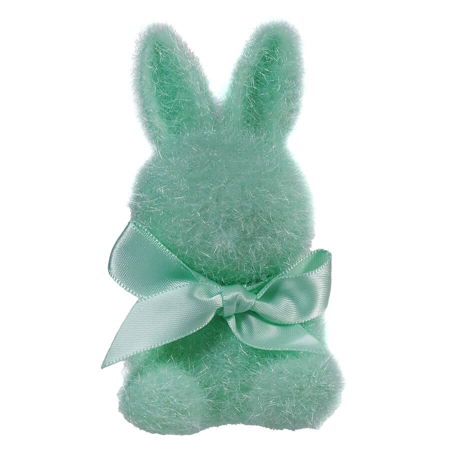 Mint green plush bunny with a satin bow around its neck.