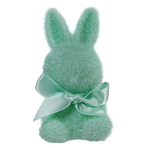 Mint green plush bunny with a satin bow around its neck.