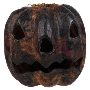 Small black oval carved pumpkin with weathered charcoal finish rust patina and carved triangular face for tabletop decor