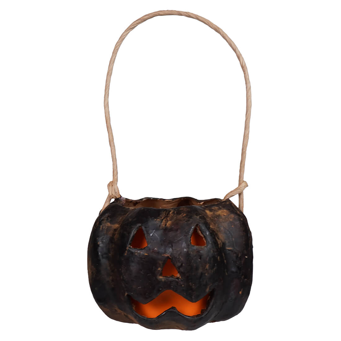 Small carved black pumpkin bucket made of hand-painted paper mache with glowing orange interior and natural twine handle