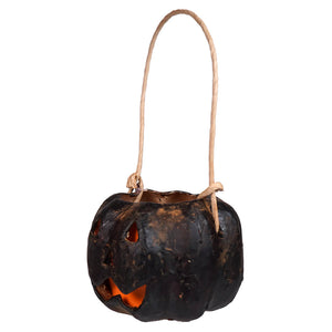 Small carved black pumpkin bucket with hand-painted paper mache and glowing carved black pumpkin design with twine handle