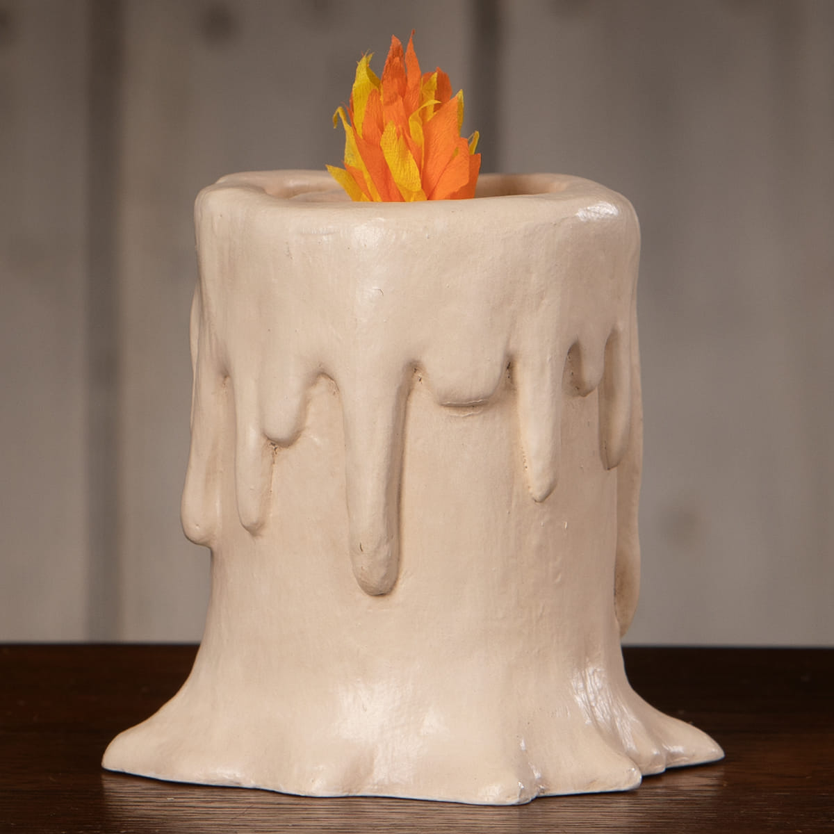 Cream-colored ceramic small flam’in candle luminary with faux orange and yellow flame decoration
