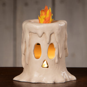 Cream-colored ceramic small flam’in candle luminary with glowing orange and yellow paper flame on top