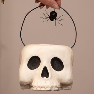 Small grim bucket halloween bucket with white skull shape black wire handle and spider skeleton decor figure