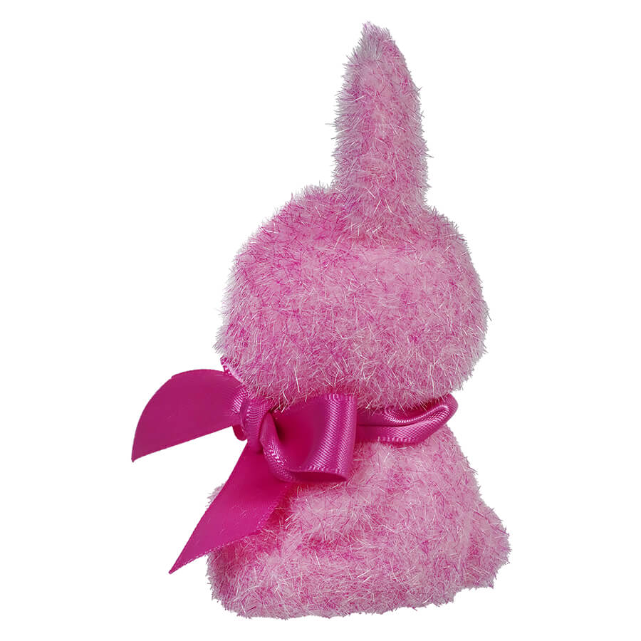 Pink plush bunny with a magenta bow tied around its neck.