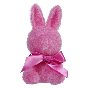 Pink fluffy bunny plush with a satin bow around its neck.