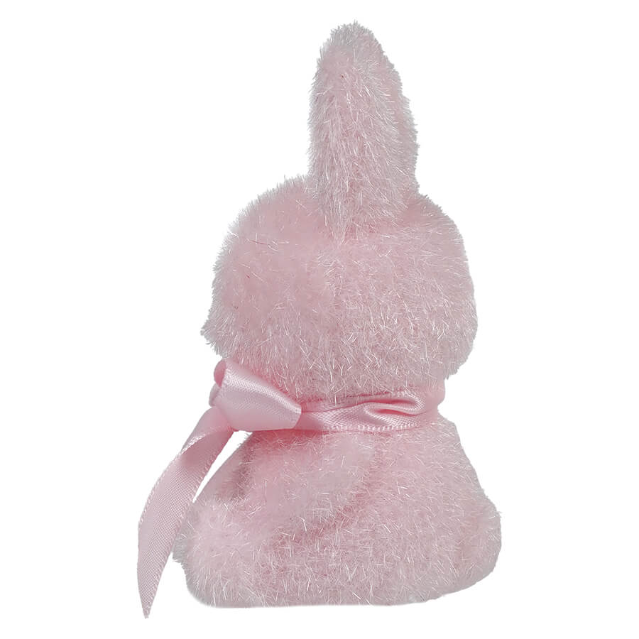 Pink plush bunny with a satin bow tied around its middle.