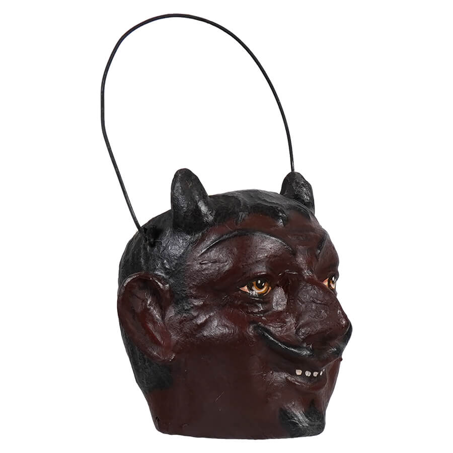 Dark reddish-brown devil head ornament with pointed ears and glowing yellow eyes.