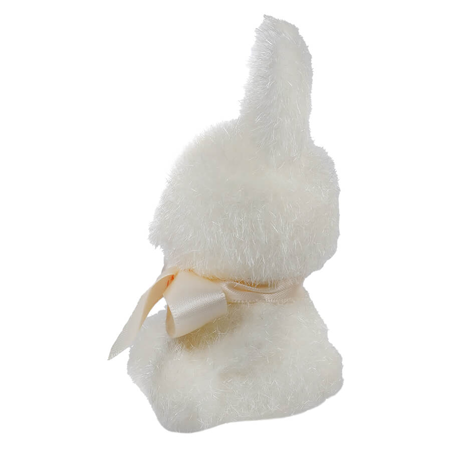 White plush bunny with a cream-colored bow around its neck.