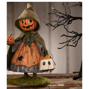 A whimsical susie pumpkin figurine by bethany lowe featuring a pumpkin-headed girl in an olive-green hooded cloak