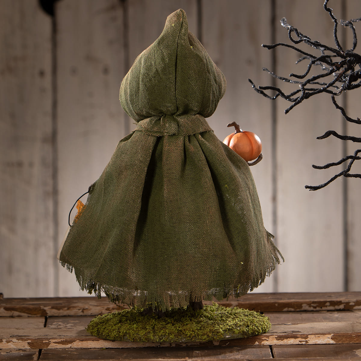 Smiling susie pumpkin bethany lowe witch figurine in olive green burlap holding orange pumpkin with frayed hem