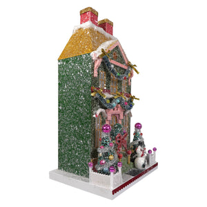 Glittery green cody foster snowman manor house ornament with pink trim gold roof and festive garlands with snowman