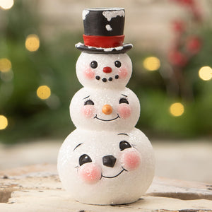 A charming bethany lowe design snowman stack candlestick with glittery white body and festive black red top hat