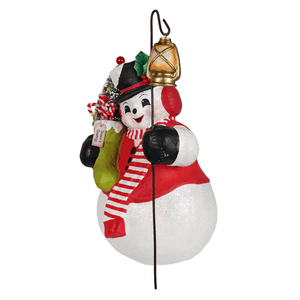 A cheerful white glittery snowman stanley ornament with a red black scarf green stocking candy canes and gold lantern by bethany lowe designs