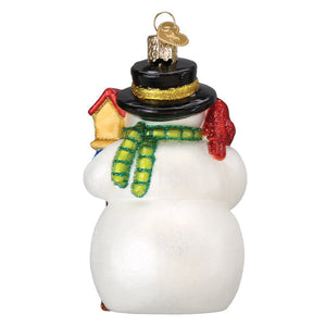 White glass gleeful snowman ornament with black top hat, green glittery scarf, red gloves, and figural decor style
