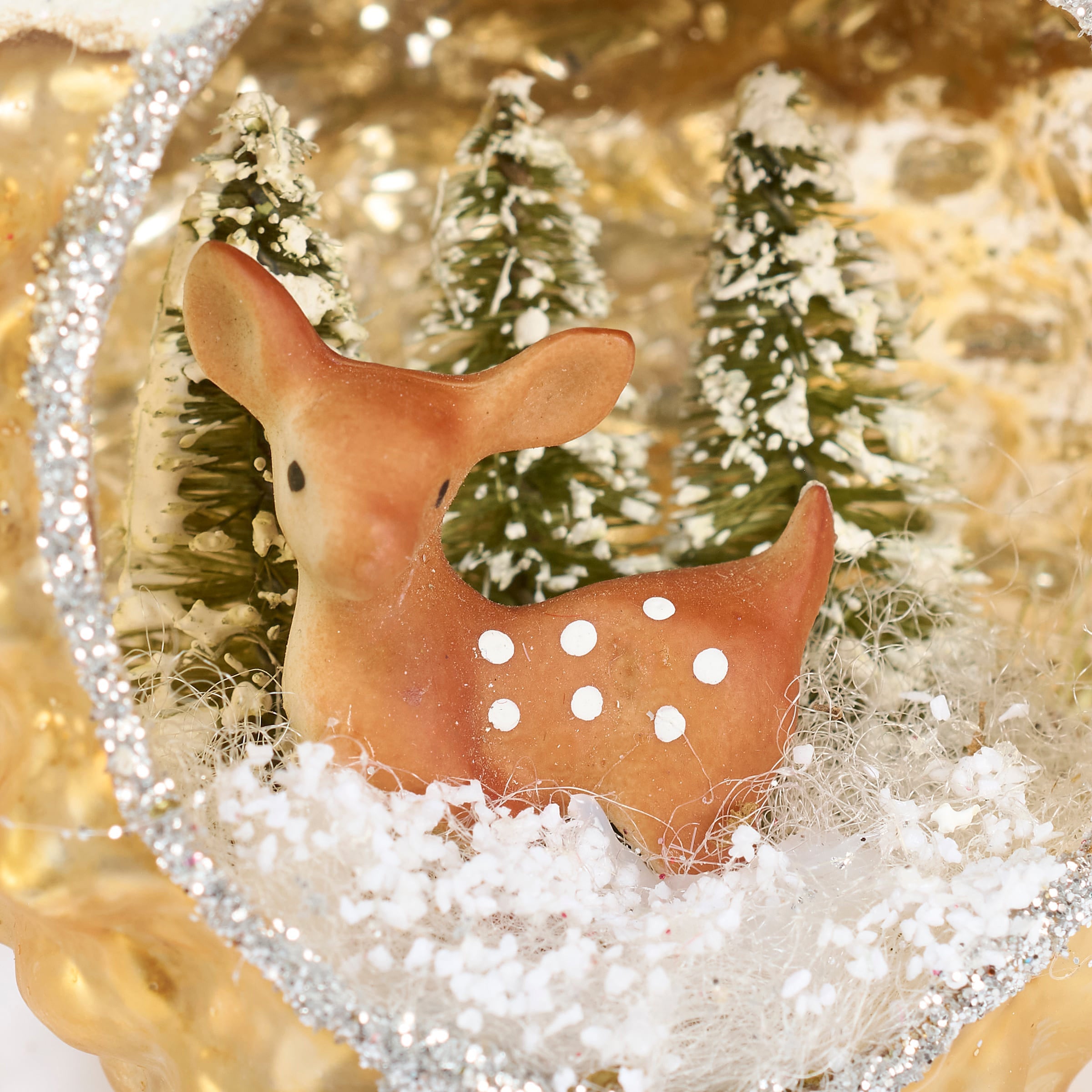Brown ceramic snowy deer glass ornament with white polka dots nestled in snow among mini trees perfect year-round decor