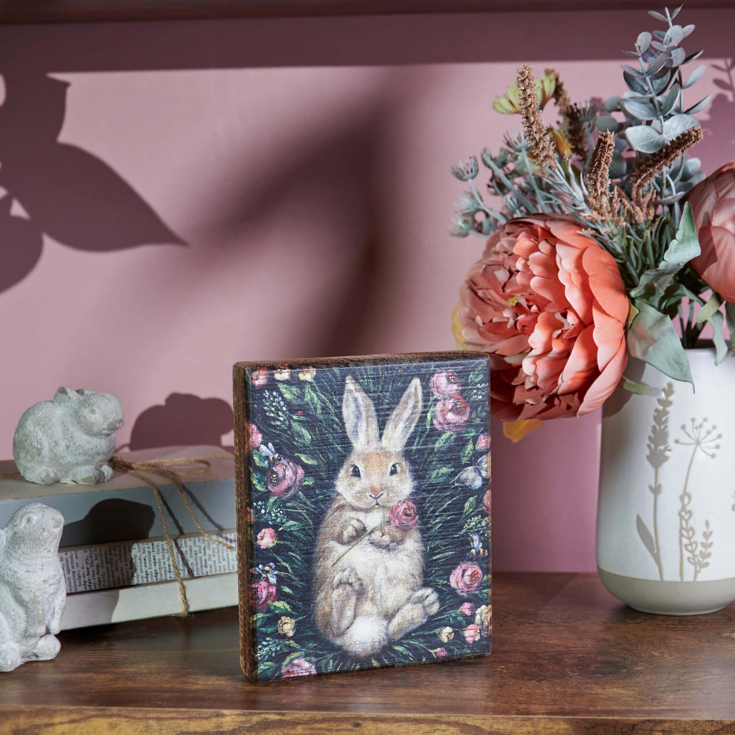 Decorative notebook or journal featuring a painted bunny surrounded by floral designs on its cover.