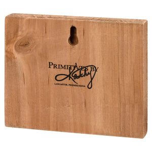 Wooden plaque or sign with ’Primitive By Kathy’ text from Lancaster, Pennsylvania.