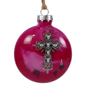 A vibrant fuchsia glass southwestern cross christmas ornament with silver pearls and subtle cactus silhouettes by Fraser Day