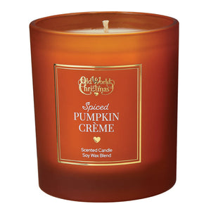 A warm amber glass spiced pumpkin creme candle by old world christmas pairs well with red dot taper candles and creative co-op sets