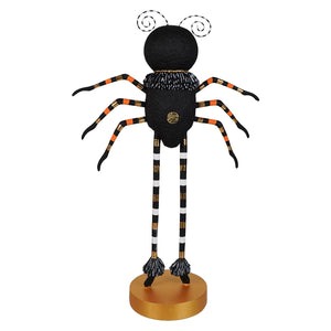 Black spider halloween figure with orange white striped legs gold accents and spiral antennae on a golden base for halloween display